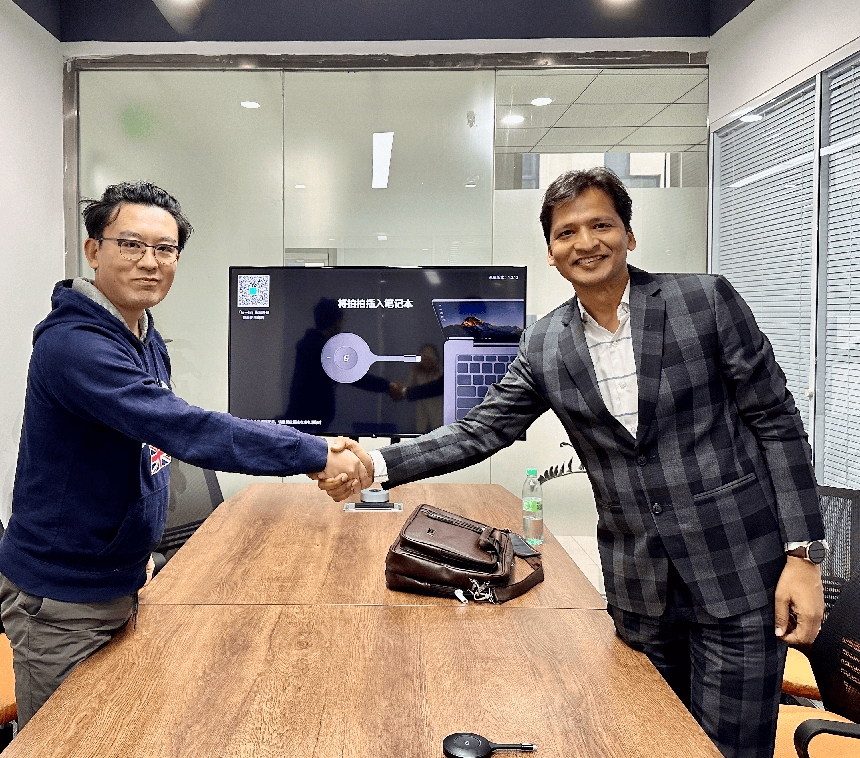 eQOURSE Business Partnership Meeting in China — China 2024. An eQOURSE representative concluding a professional business meeting with a handshake during the China Business Tour 2024, reflecting…